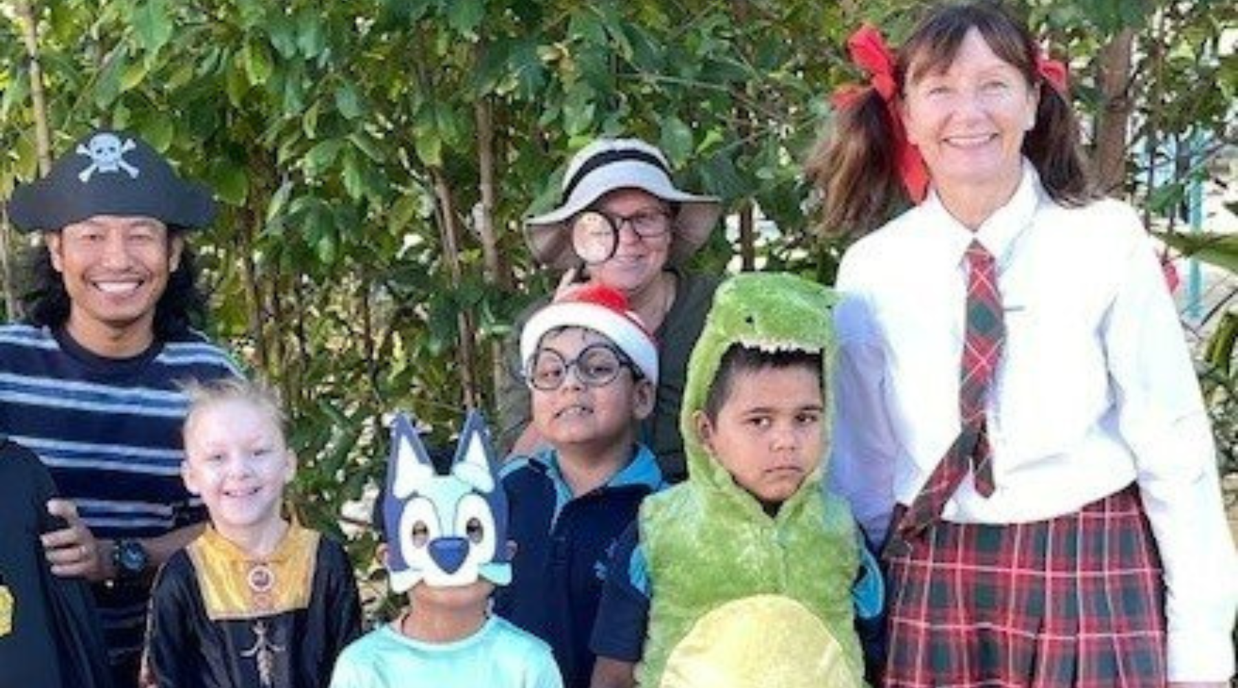 A group of people dressed in costumes are posing for a picture.