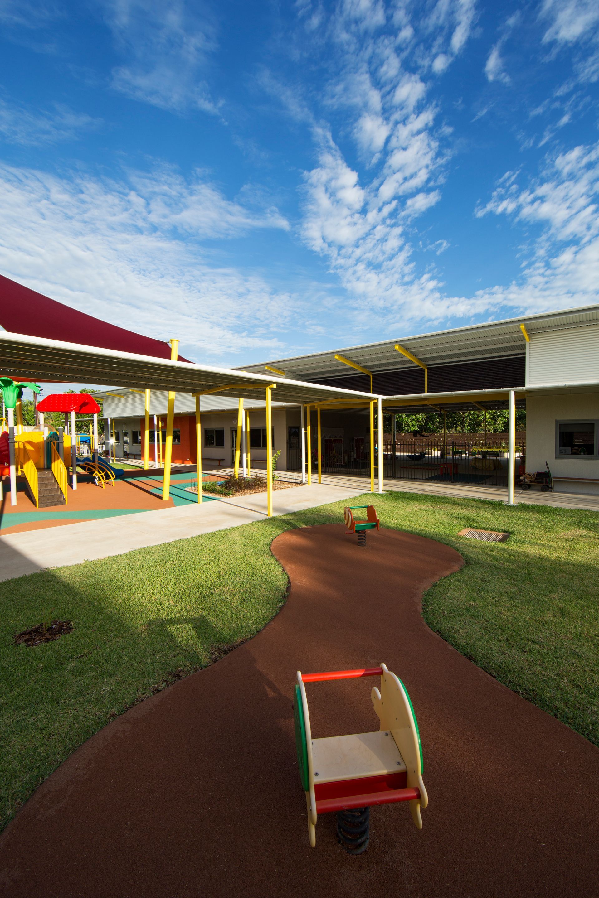 There is a playground in the middle of the courtyard.