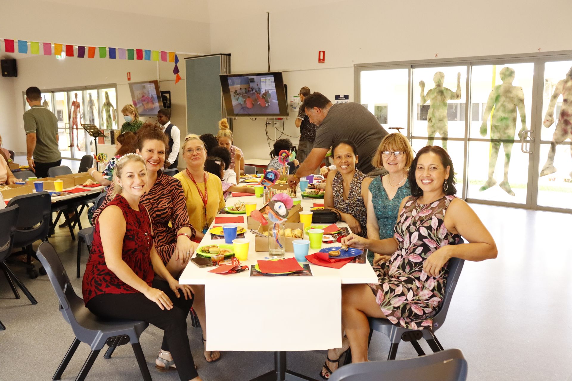 A group of people are sitting around a table in a room.