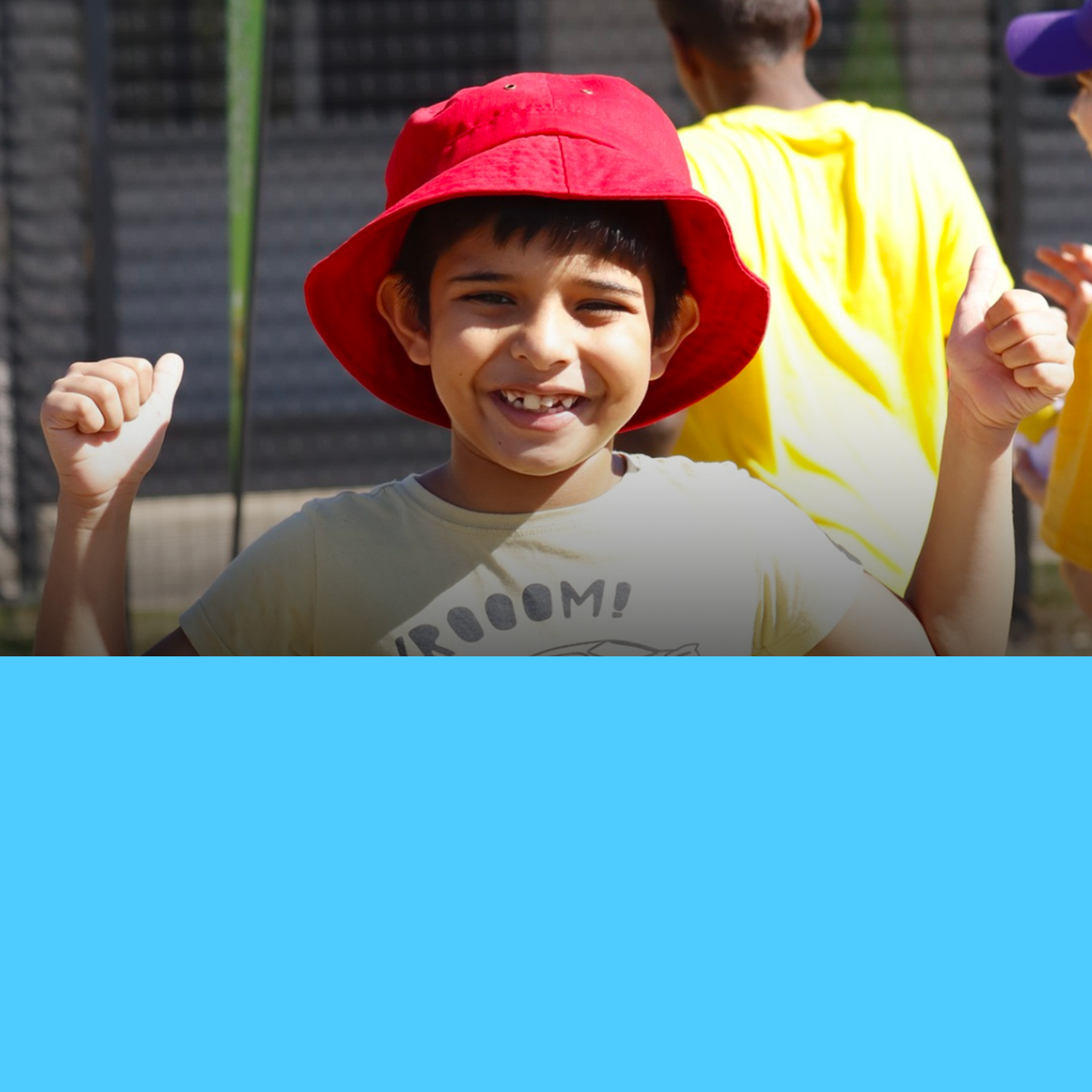 A young boy wearing a red hat and a shirt that says freedom