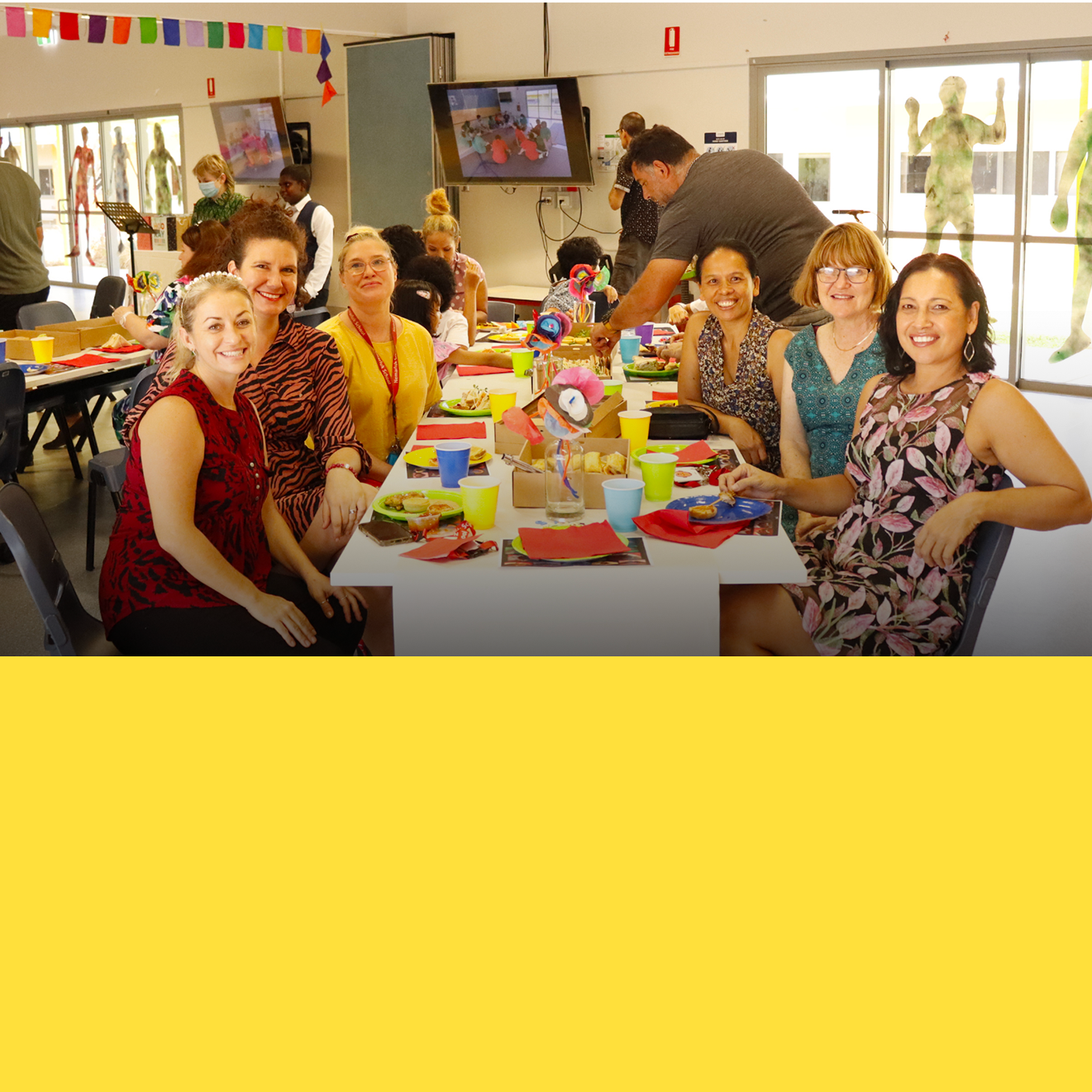 A group of people are sitting around a long table