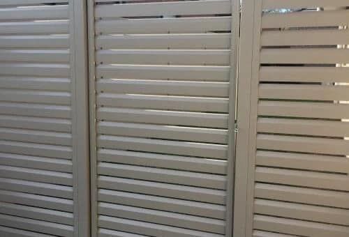 Three White Shutter Panels, Slats Angled to Allow Light and Air Flow — Metal Fencing Supplies In Wingham, NSW
