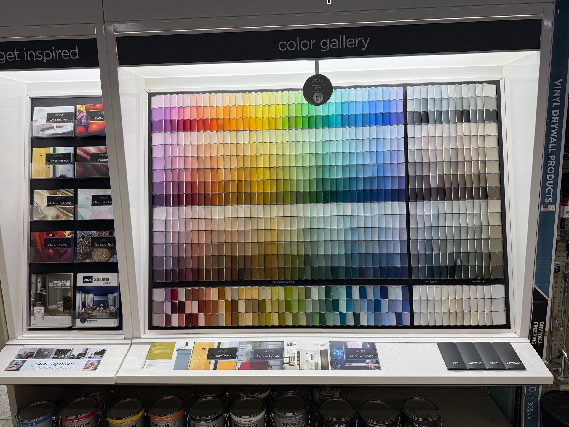 Color gallery display with rows of paints and swatches in a store showroom