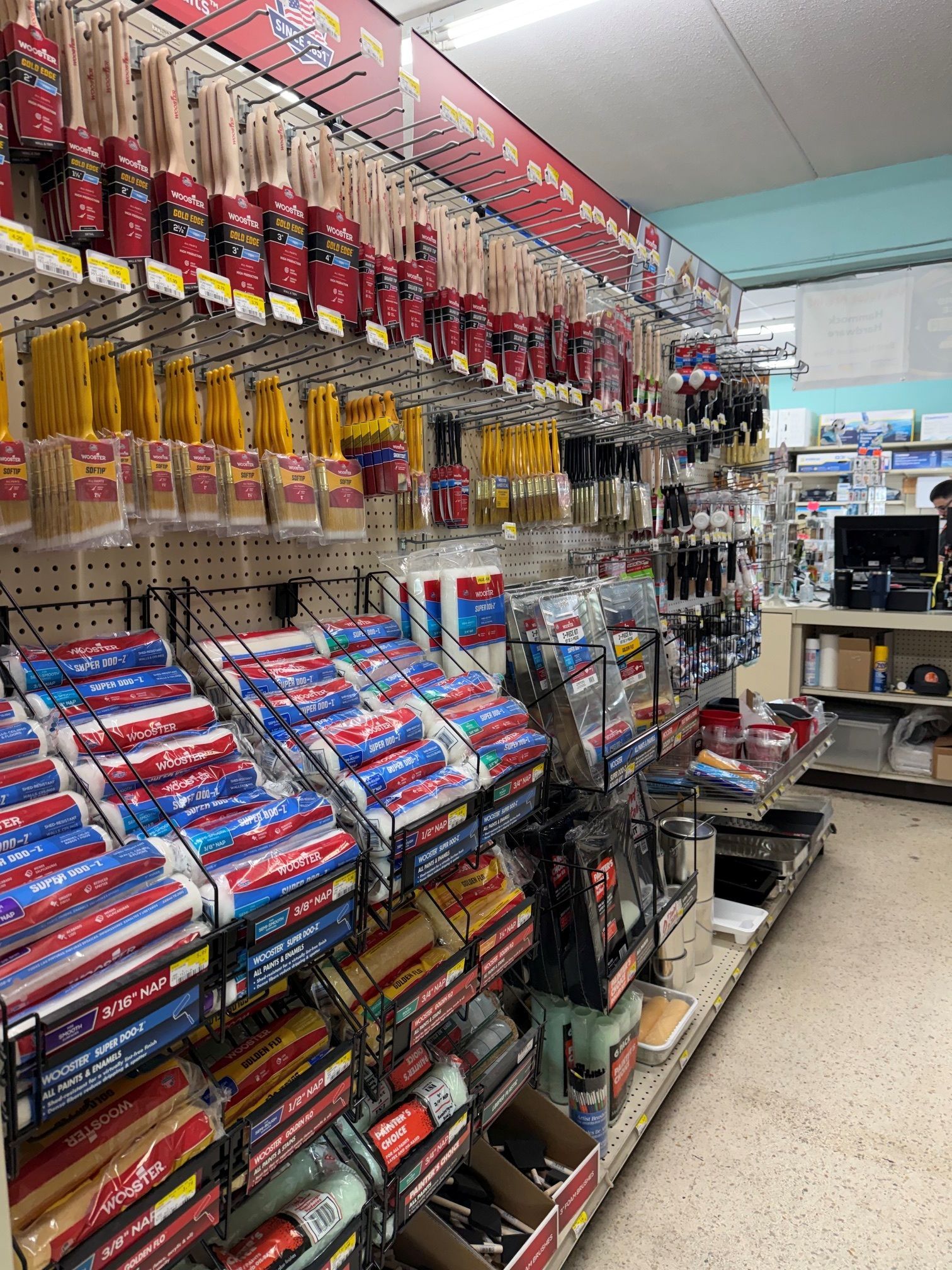 A store aisle packed with colorful hanging snacks and boxed goods on shelves.