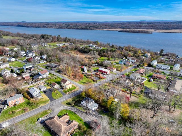 Hudson Valley Drones captures an aerial view of a small town next to a river.