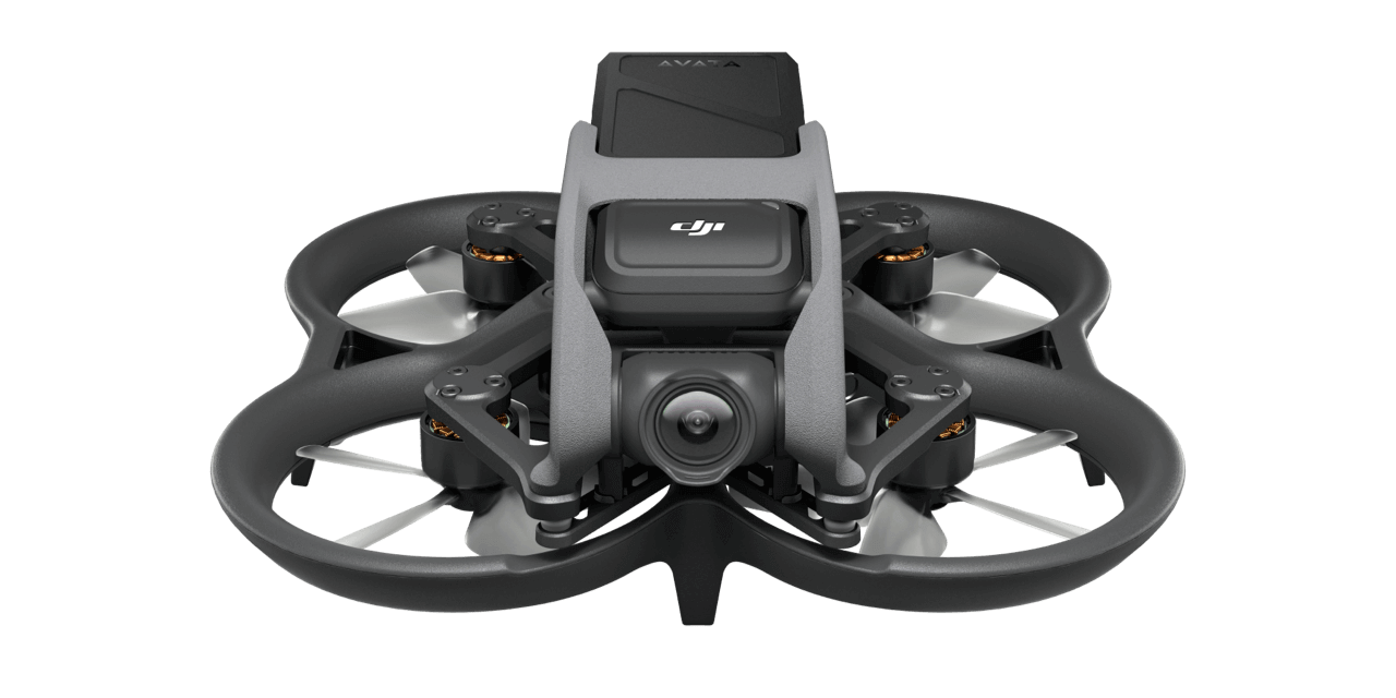 An aerial photography drone with a camera attached is displayed on a white surface.