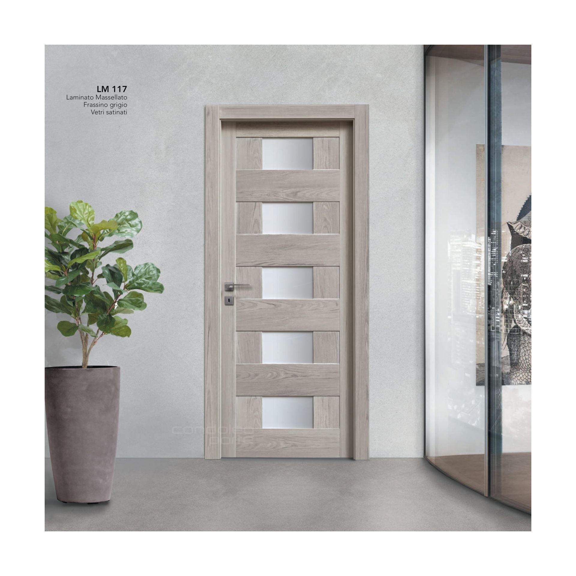Porta interna moderna color beige con pannelli in vetro satinato in un corridoio minimalista, accanto a una pianta in vaso.