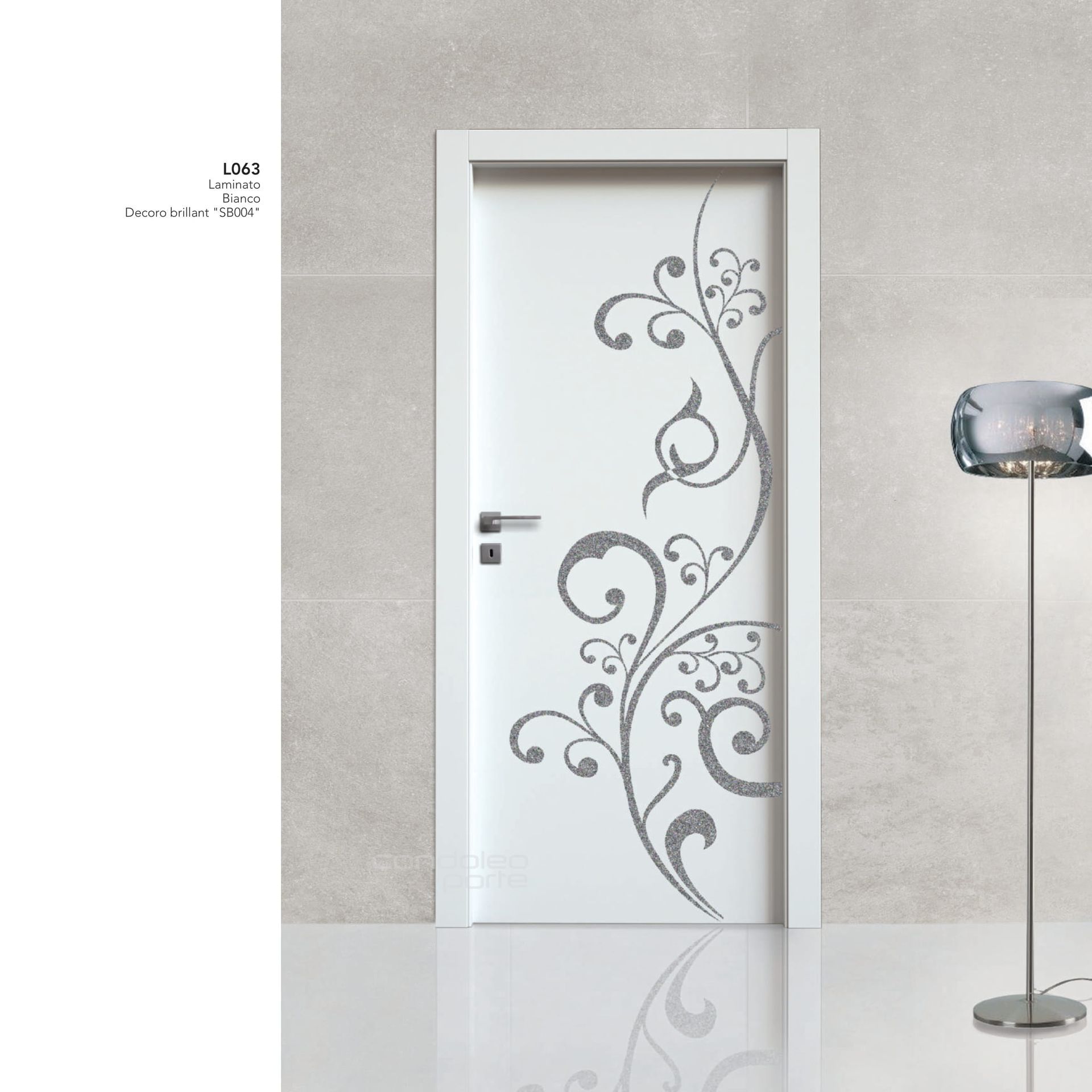 Porta interna bianca con decorazione floreale grigia a volute, accanto a una moderna lampada da terra su un pavimento lucido.