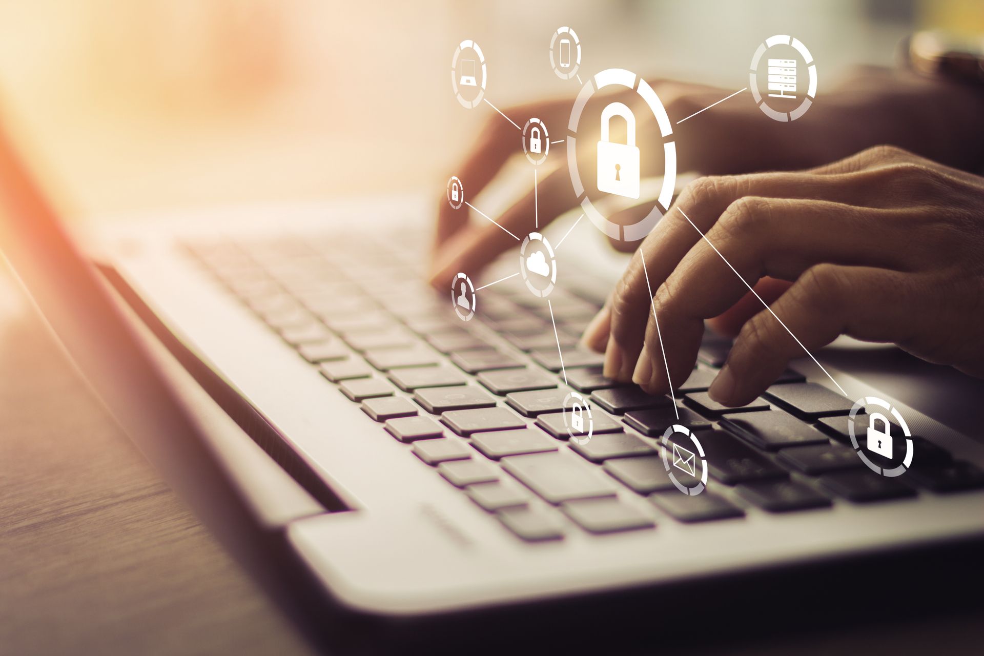 Hands typing on laptop, surrounded by glowing cybersecurity icons.