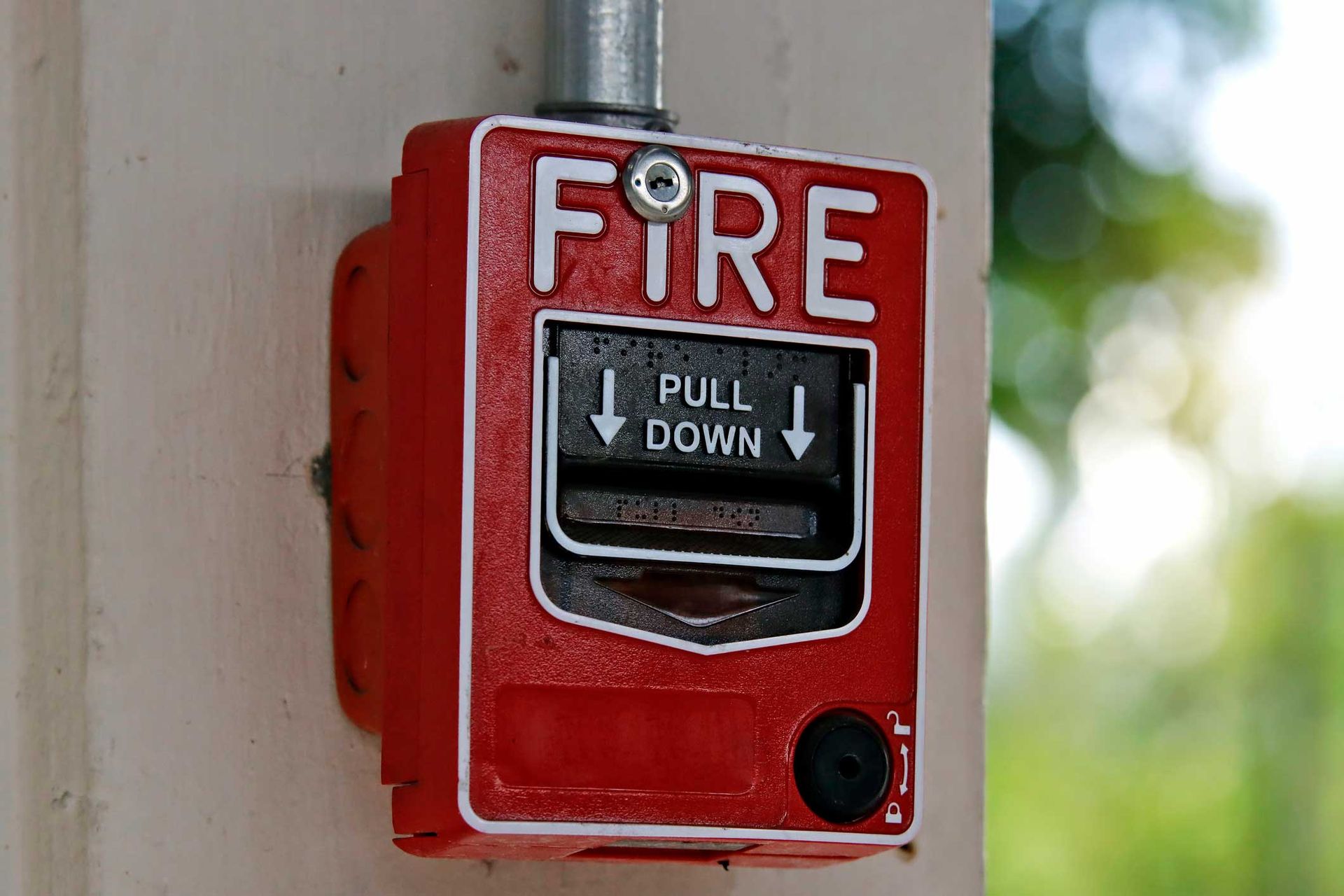 Fire alarm signal mounted on a cement wall for effective alarm and security systems.