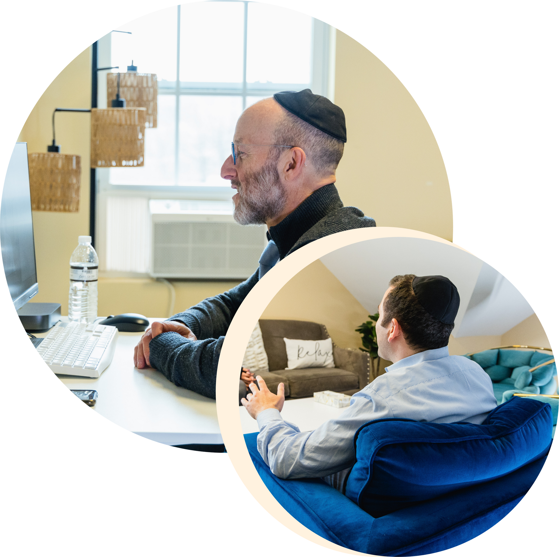 A man is sitting at a desk and another man is sitting in a chair