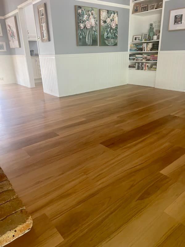 Hardwood Floor in a Room With White and Blue Walls — BLB Flooring Solutions in Maitland, NSW