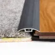 Floor Transition Strip Between Gray Carpet and Wood Flooring — BLB Flooring Solutions in Central Coast, NSW
