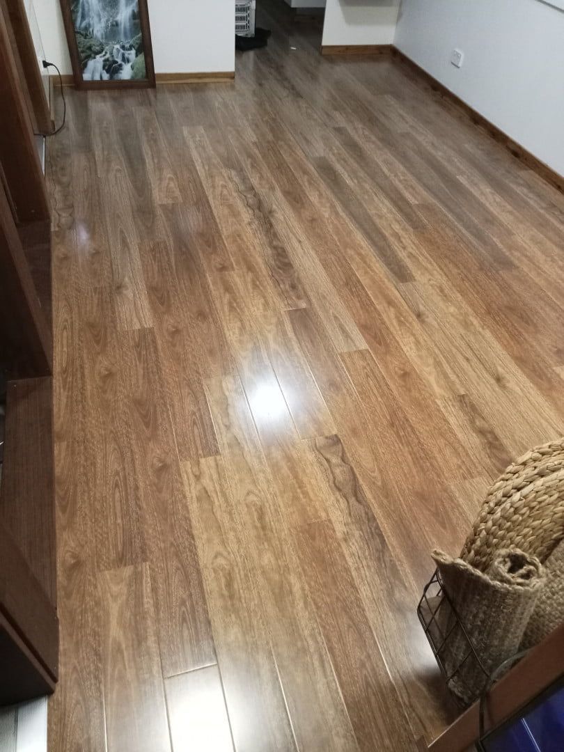 A Living Room With a Wooden Floor and a Basket on the Floor — BLB Flooring Solutions in Central Coast, NSW