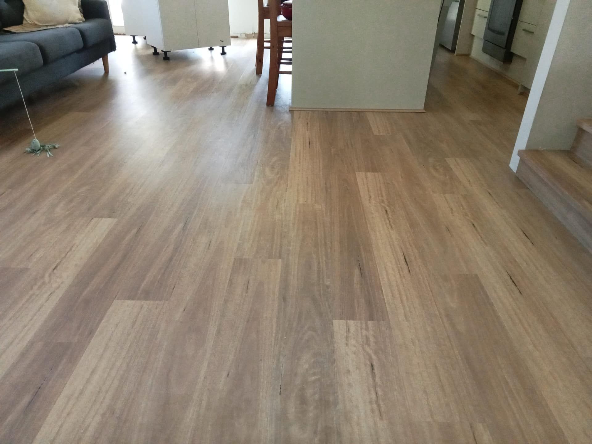 A Living Room With a Wooden Floor and a Couch — BLB Flooring Solutions in Central Coast, NSW