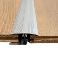 Metal Floor Transition Strip Installed Between Two Wooden Planks — BLB Flooring Solutions in Central Coast, NSW