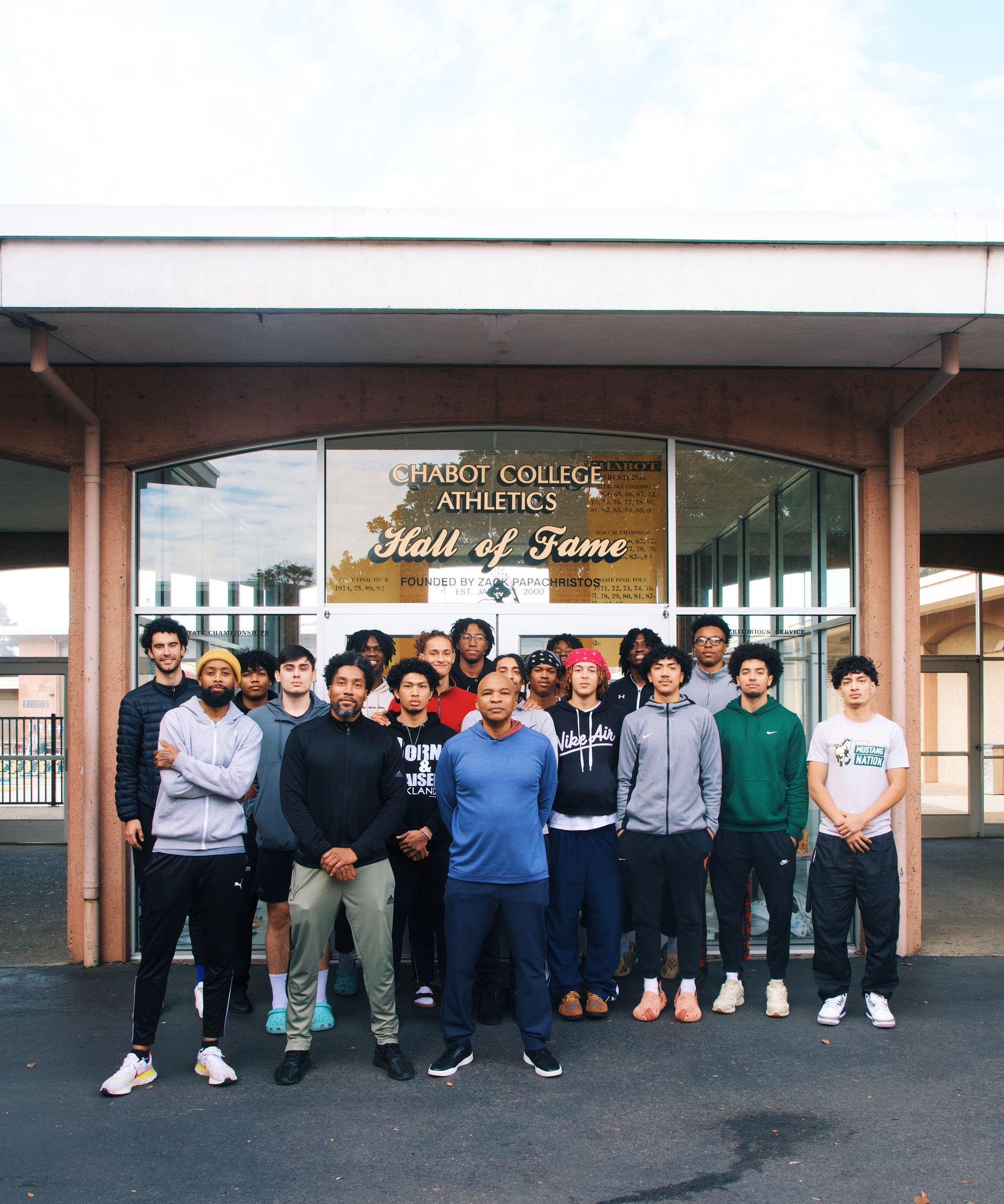 Group of men outside, in front of 