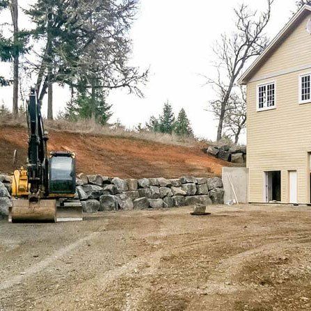 Excavator Outside the House — Eugene, OR — Braun Excavating Inc.