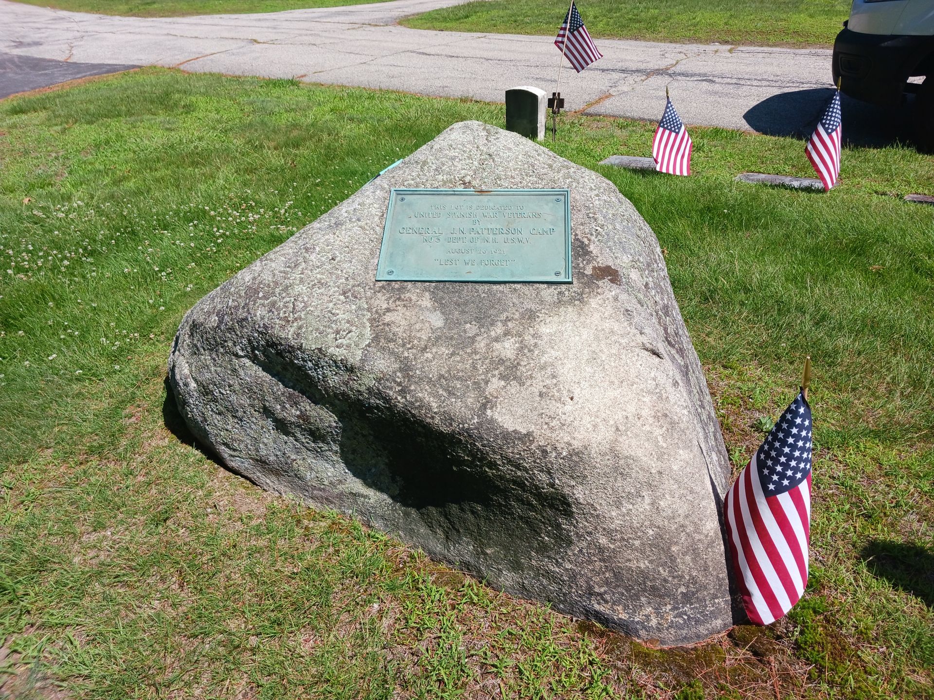 Large rock with lichen and brass plate dedicating the lot to United Spanish War Veterans by Gen. JN Patterson Camp