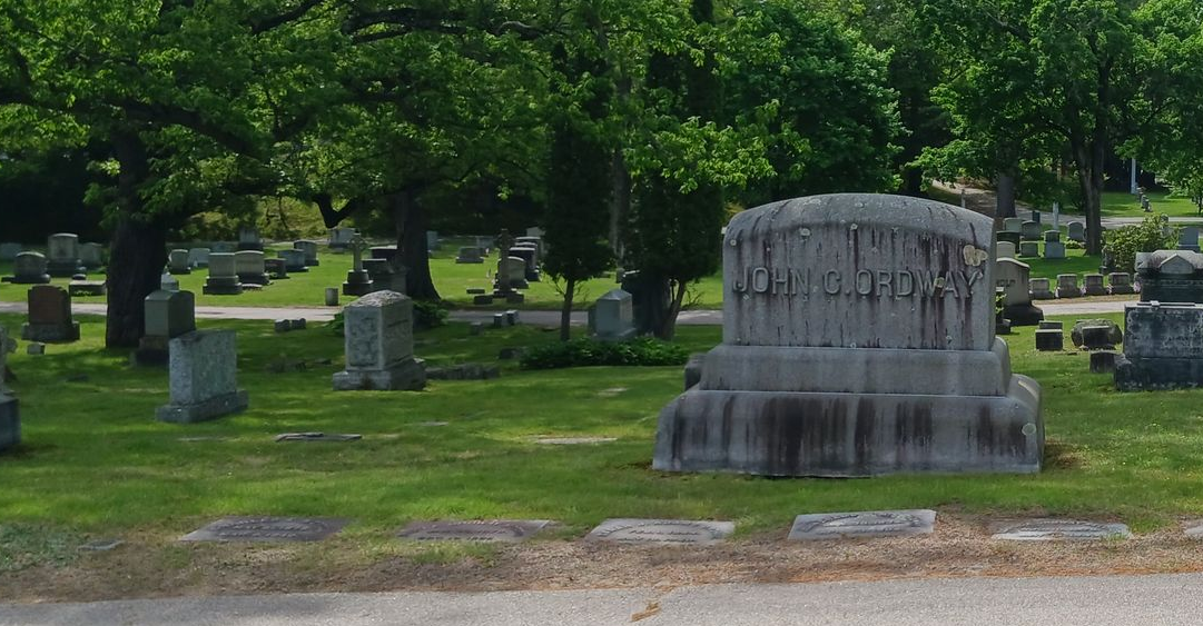 Very large granite monument with heavy staining and lichen