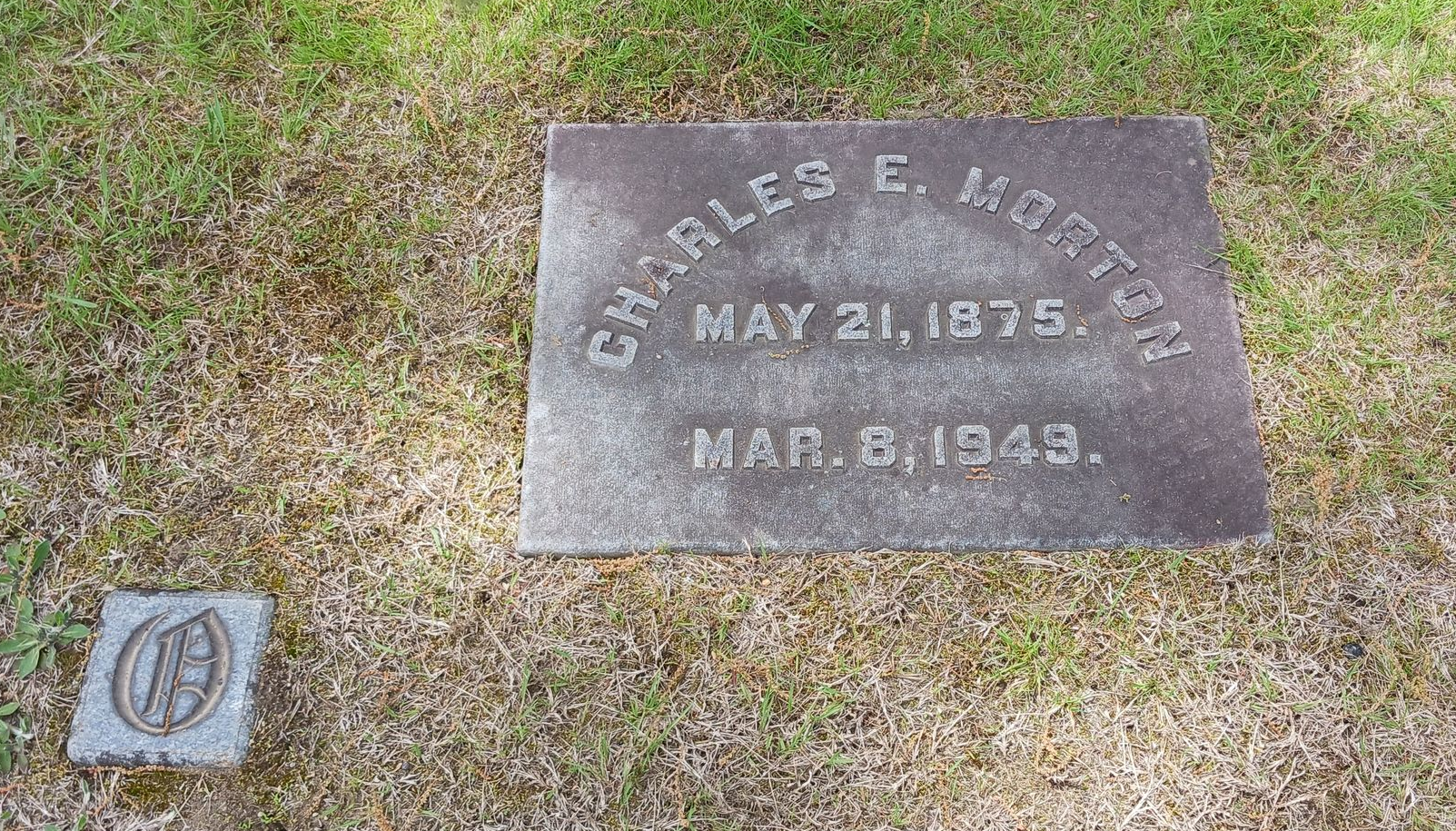 Stained granite footstone and corner marker