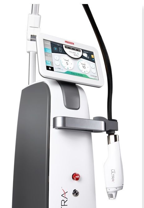 White medical laser/skin treatment device with touchscreen and attached handpiece