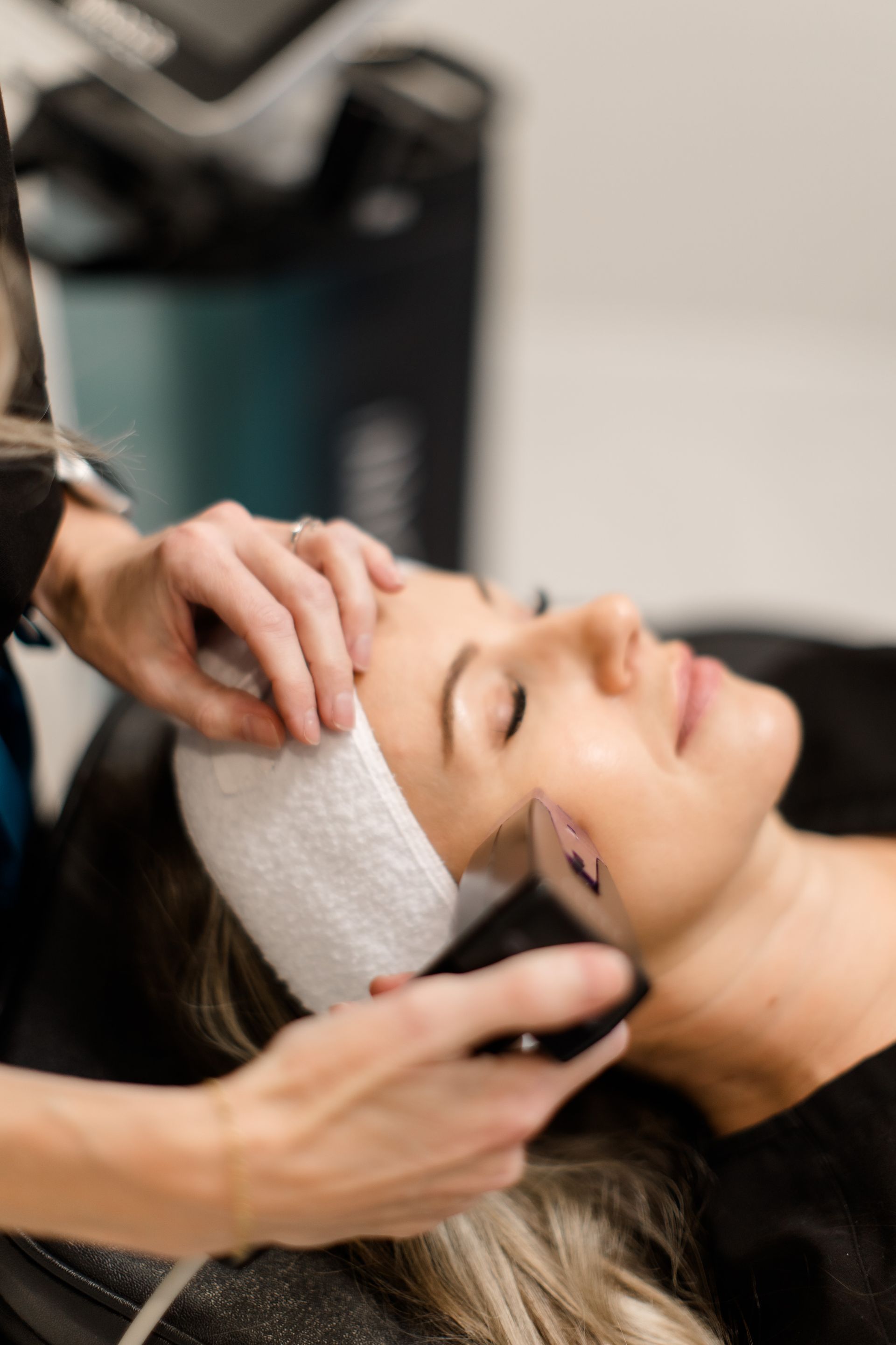 A woman is getting a facial treatment at a beauty salon.