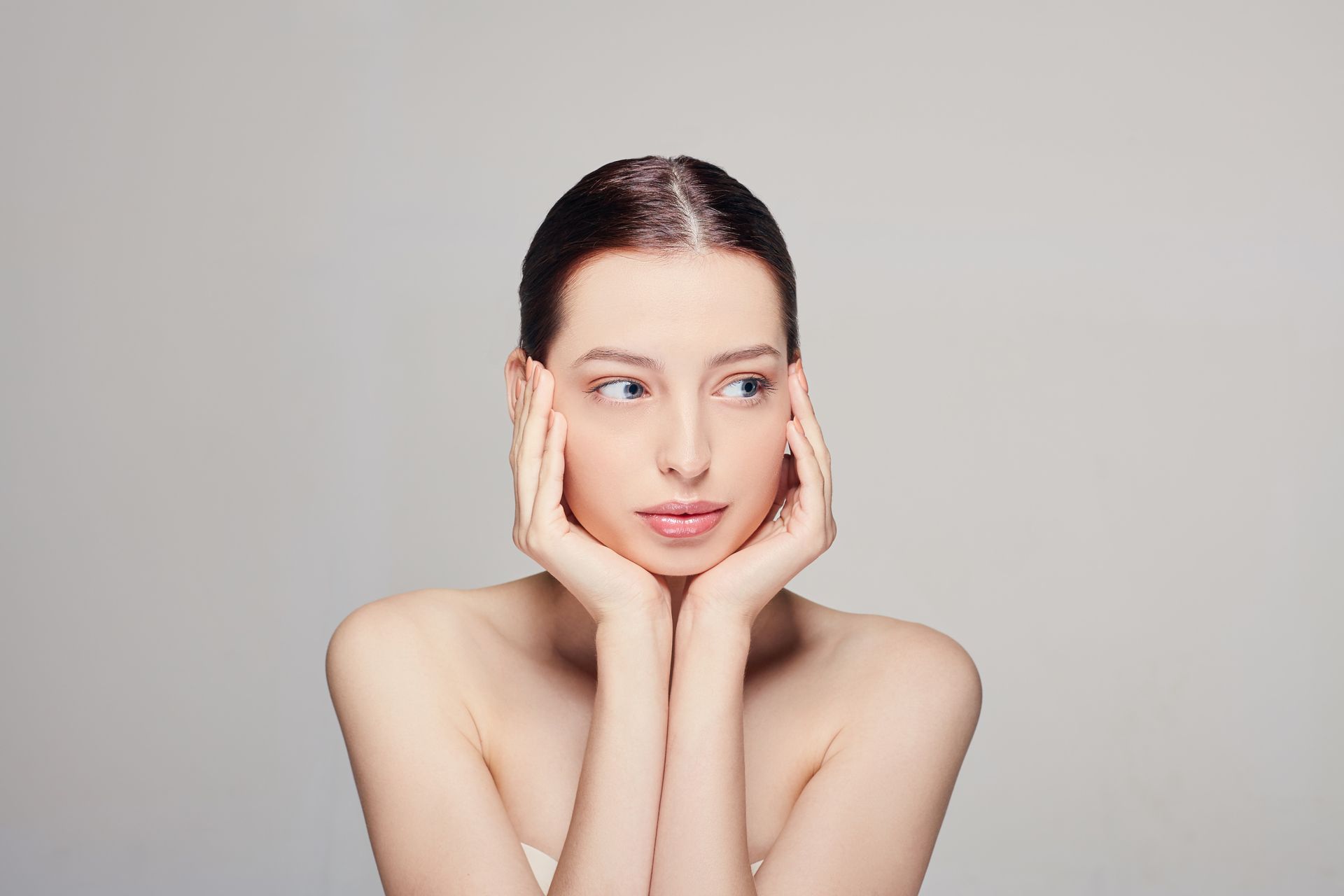 A woman with her hands on her face.