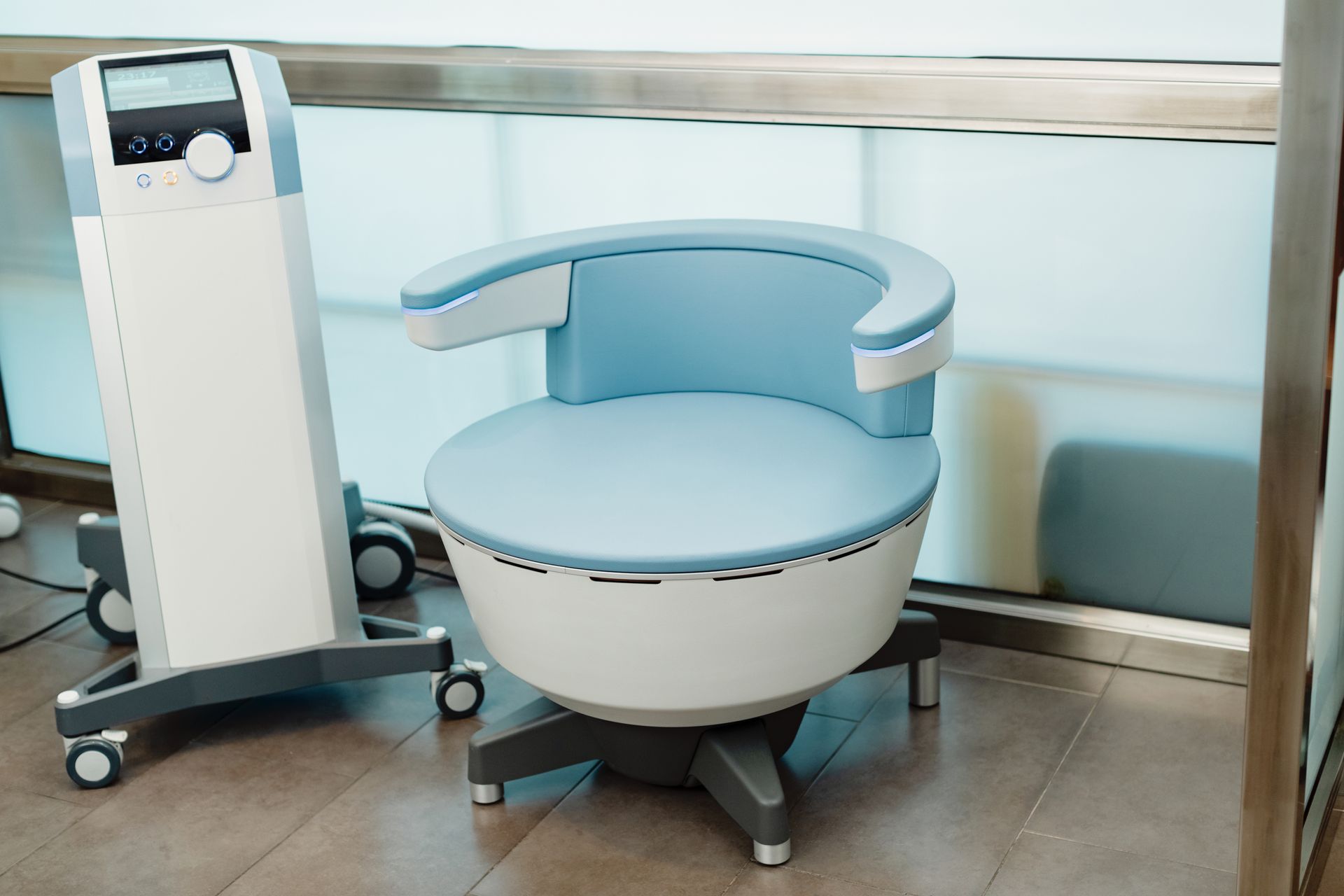 A chair is sitting next to a machine in a room.
