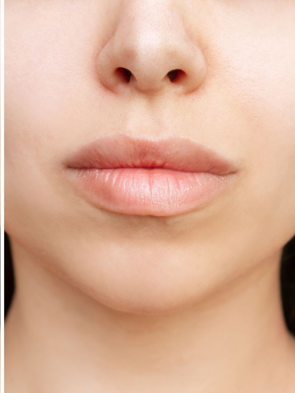A close up of a woman 's lips and nose.