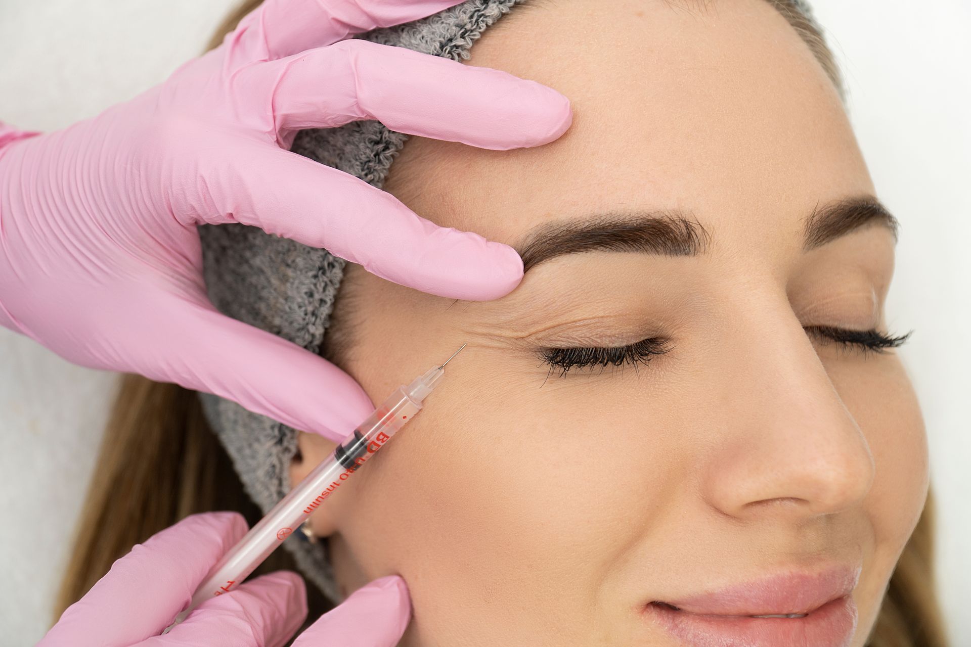 A woman is getting an injection in her eye.