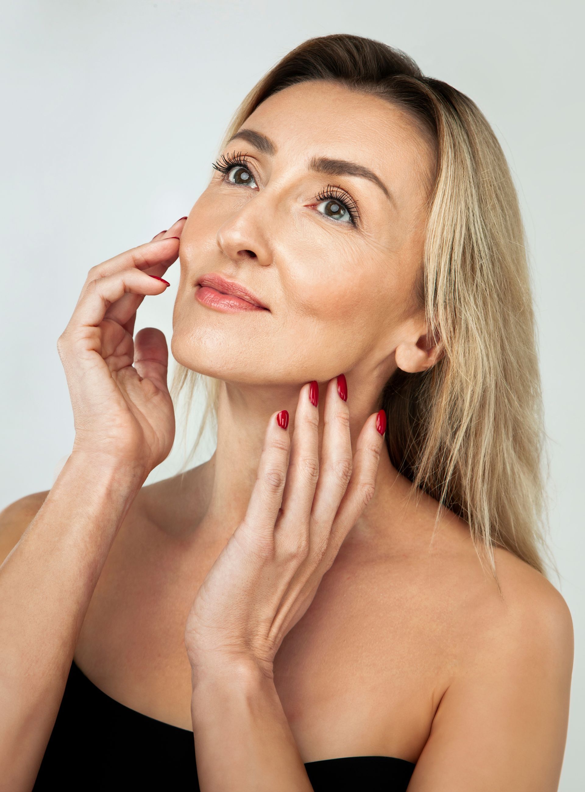 a woman touching her face.