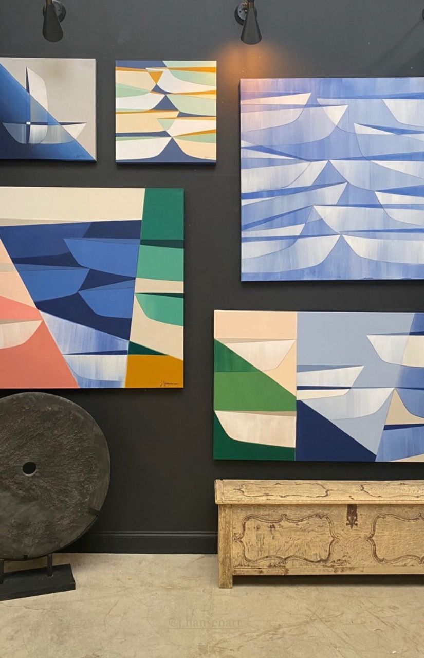 A wall with a bunch of paintings on it