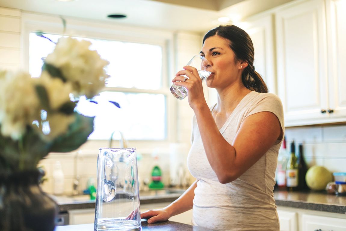 Woman Drinking Water — Jacksonville, FL — Florida Water Technologies Inc. A woman enjoying a drinking water filtration system in Ponte Vedra Beach, FL