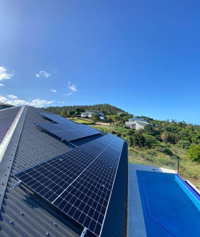A Roof With Solar Panels And A Pool In The Background — Solar Power Whitsunday In Cannon Valley, QLD