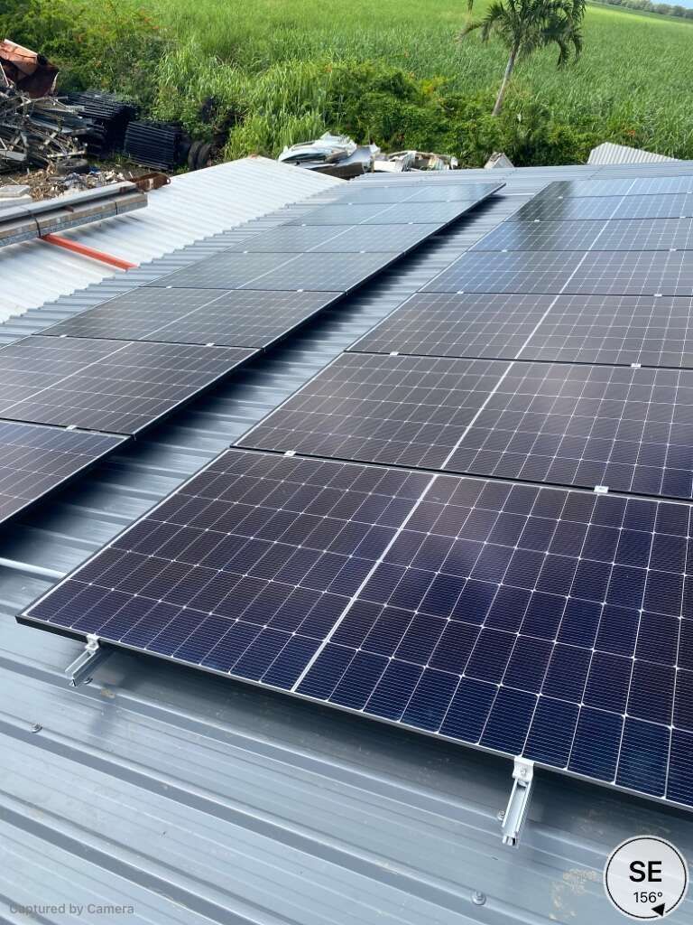 A Row Of Solar Panels Are Sitting On Top Of A Metal Roof — Solar Power Whitsunday In Proserpine, QLD