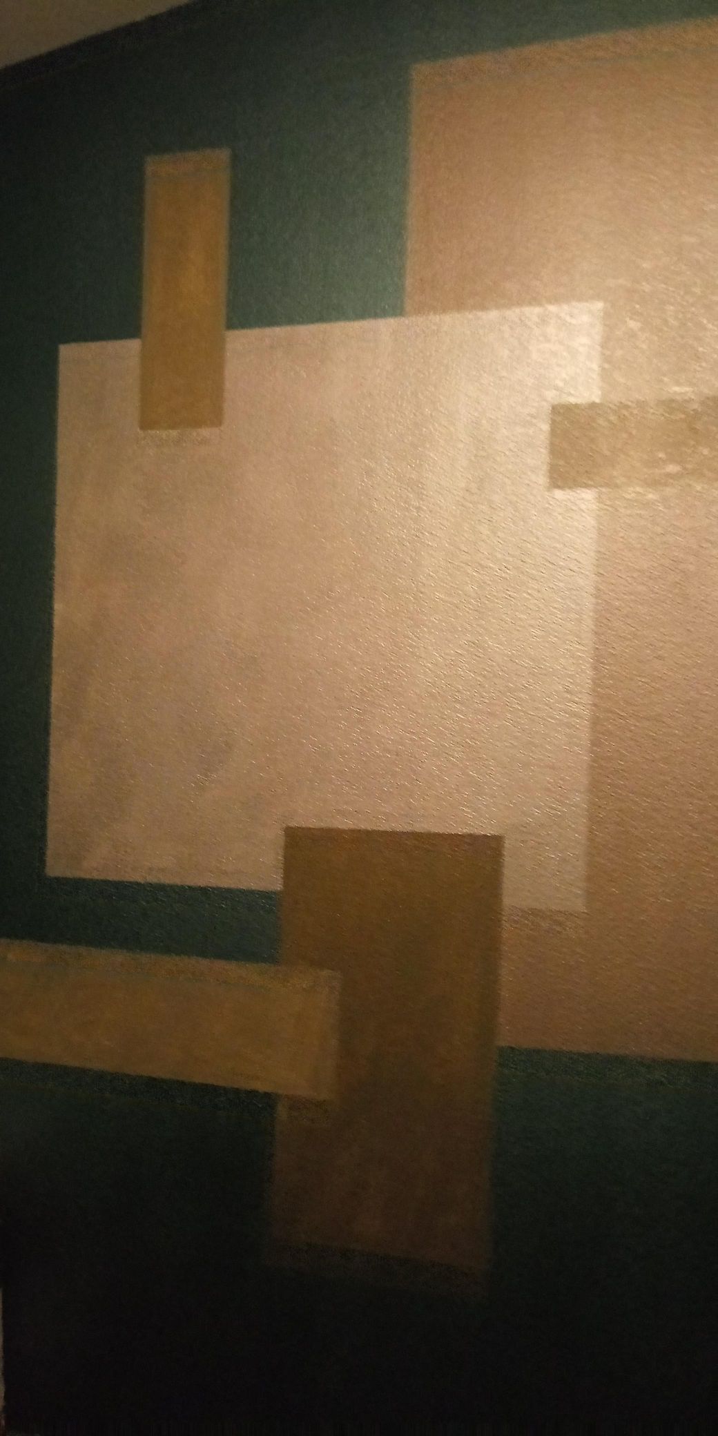 Abstract geometric wall art with overlapping tan and beige rectangles on a dark green background