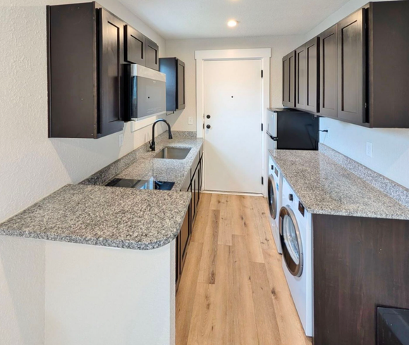 Ashley Lofts kitchen with granite countertops and stainless steel appliances