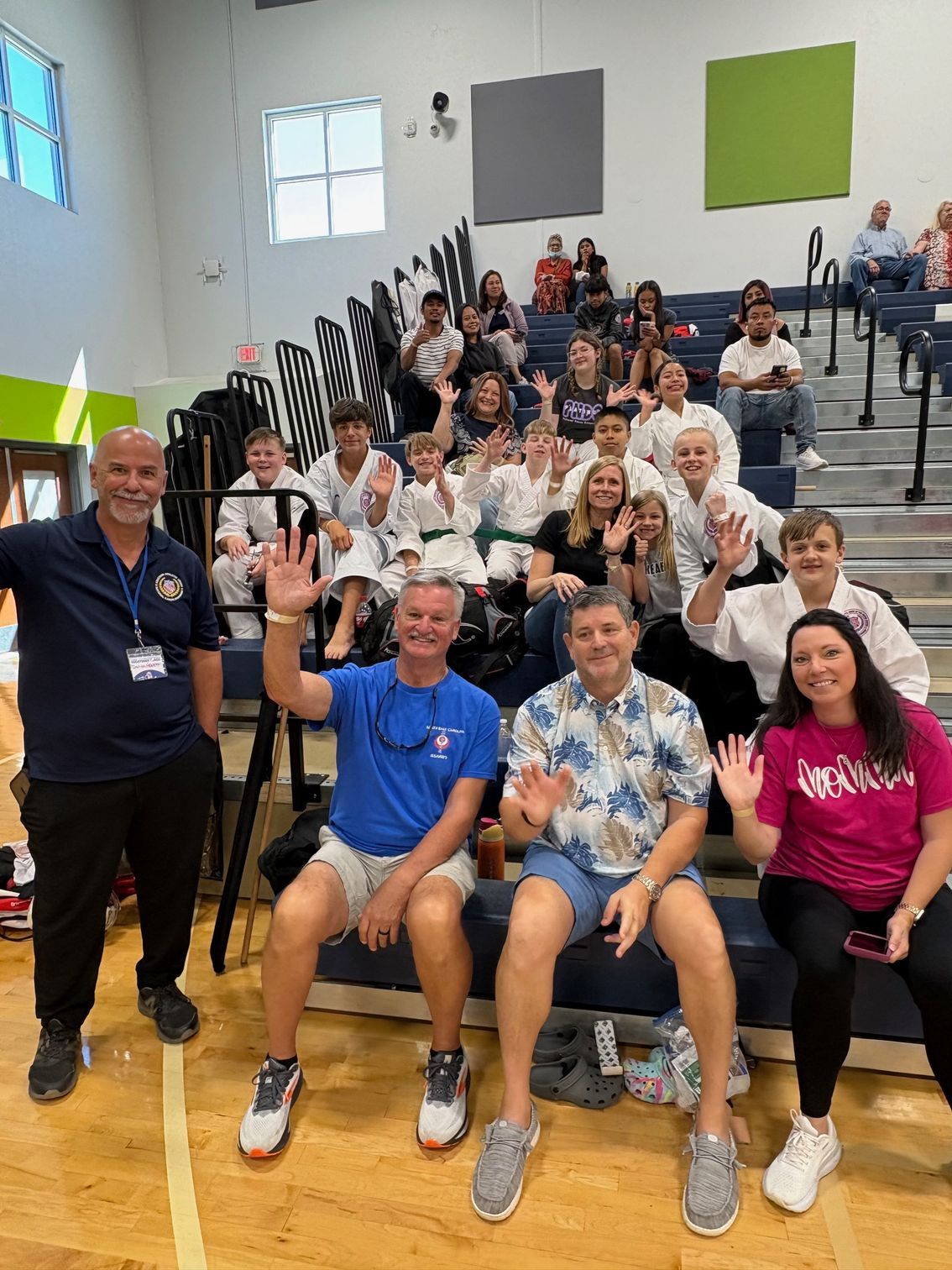A group of people standing on a mat in a gym