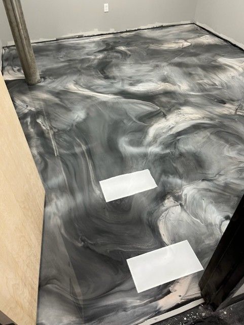 Silver and grey metallic epoxy floor swirl design by 814 Epoxy Erie PA