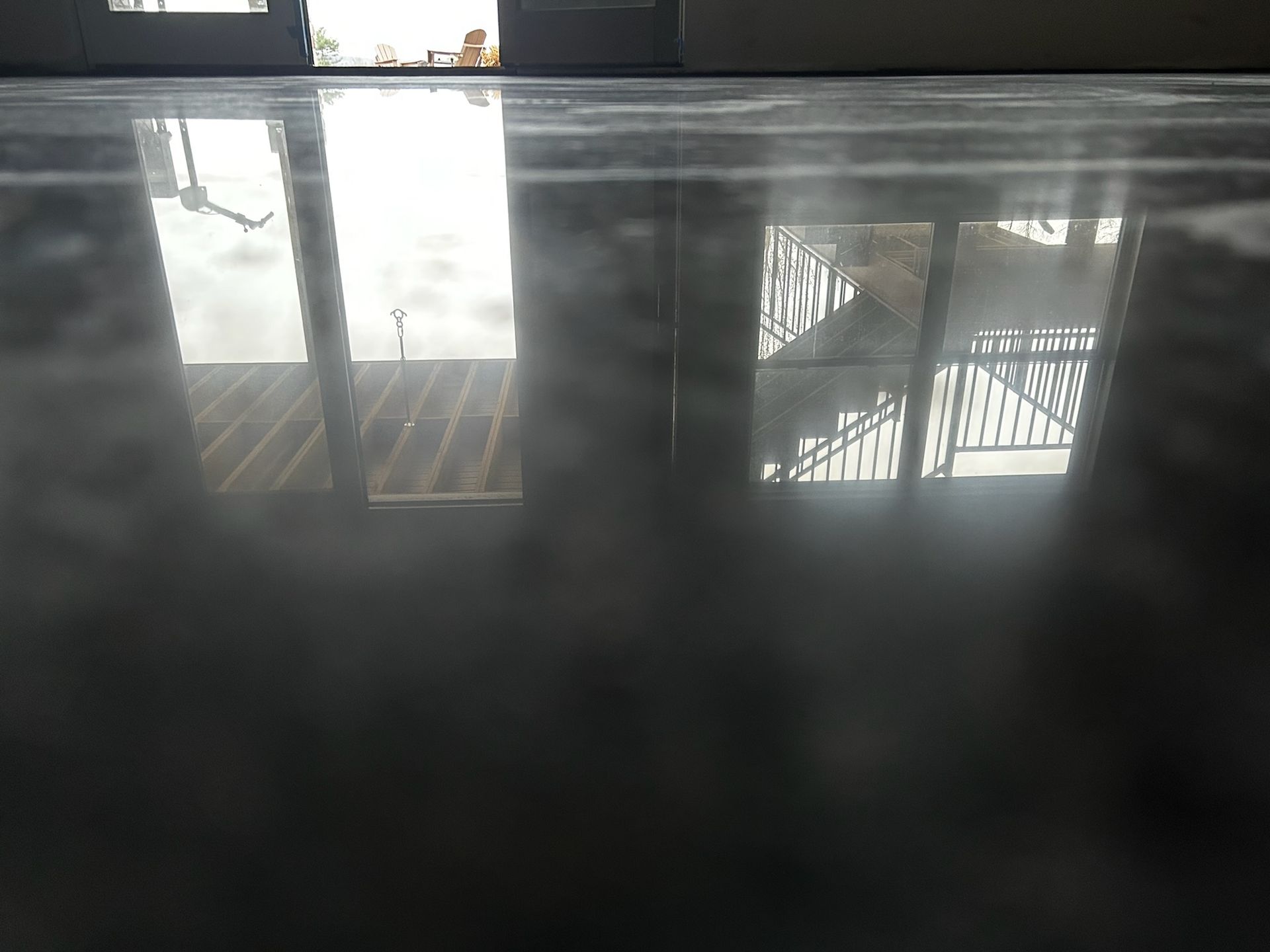 Dark dyed polished concrete floor in residential space Erie PA by 814 Epoxy