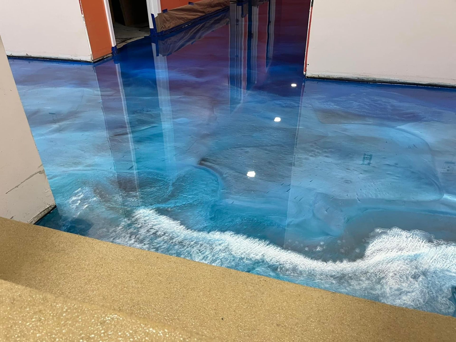 Blue metallic epoxy floor with 3D ocean effect installed by 814 Epoxy Erie PA