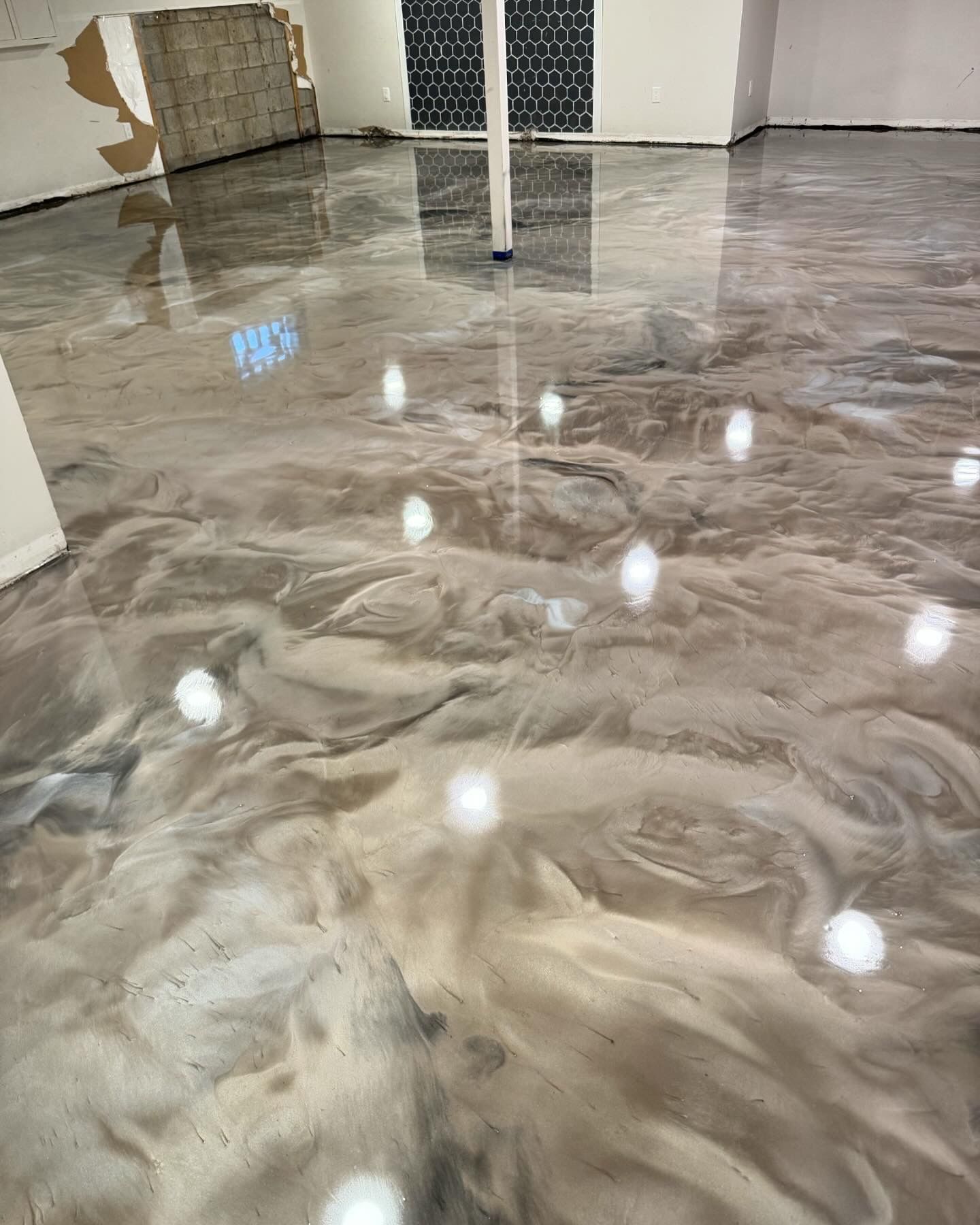 Metallic epoxy floor with swirling color depth by 814 Epoxy and More in Erie, PA