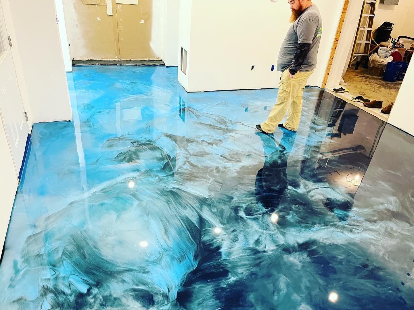 Blue ocean metallic epoxy floor being applied by 814 Epoxy team Erie PA