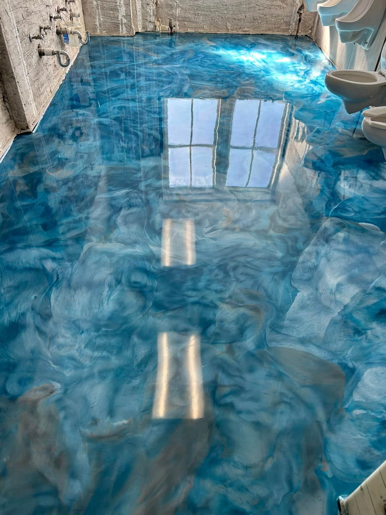 Blue metallic epoxy bathroom floor with high-gloss finish in Erie, PA