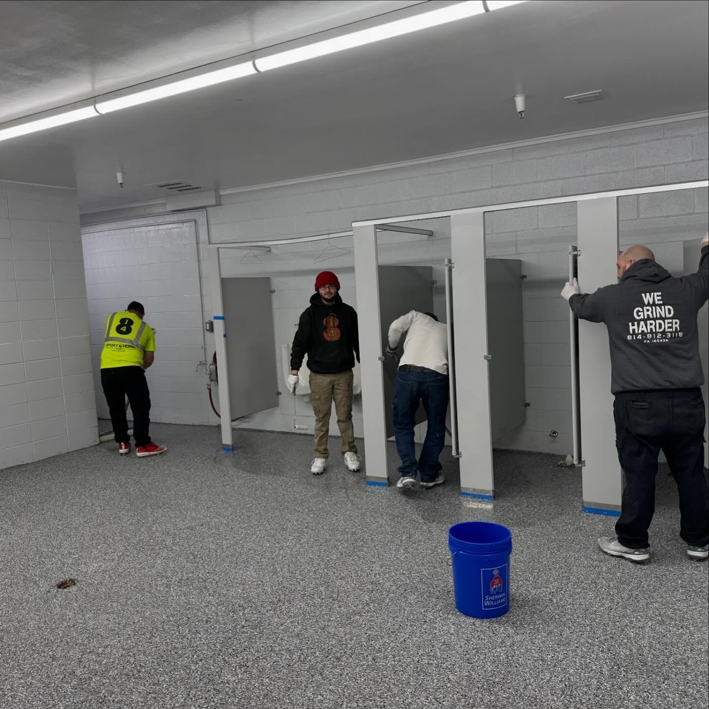 814 Epoxy We Grind Harder crew installing epoxy flake floor Erie PA