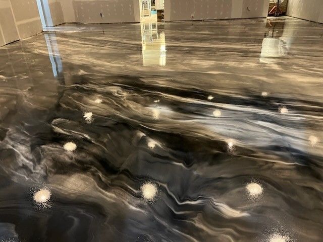 Black and gold swirl metallic epoxy floor by 814 Epoxy Erie PA