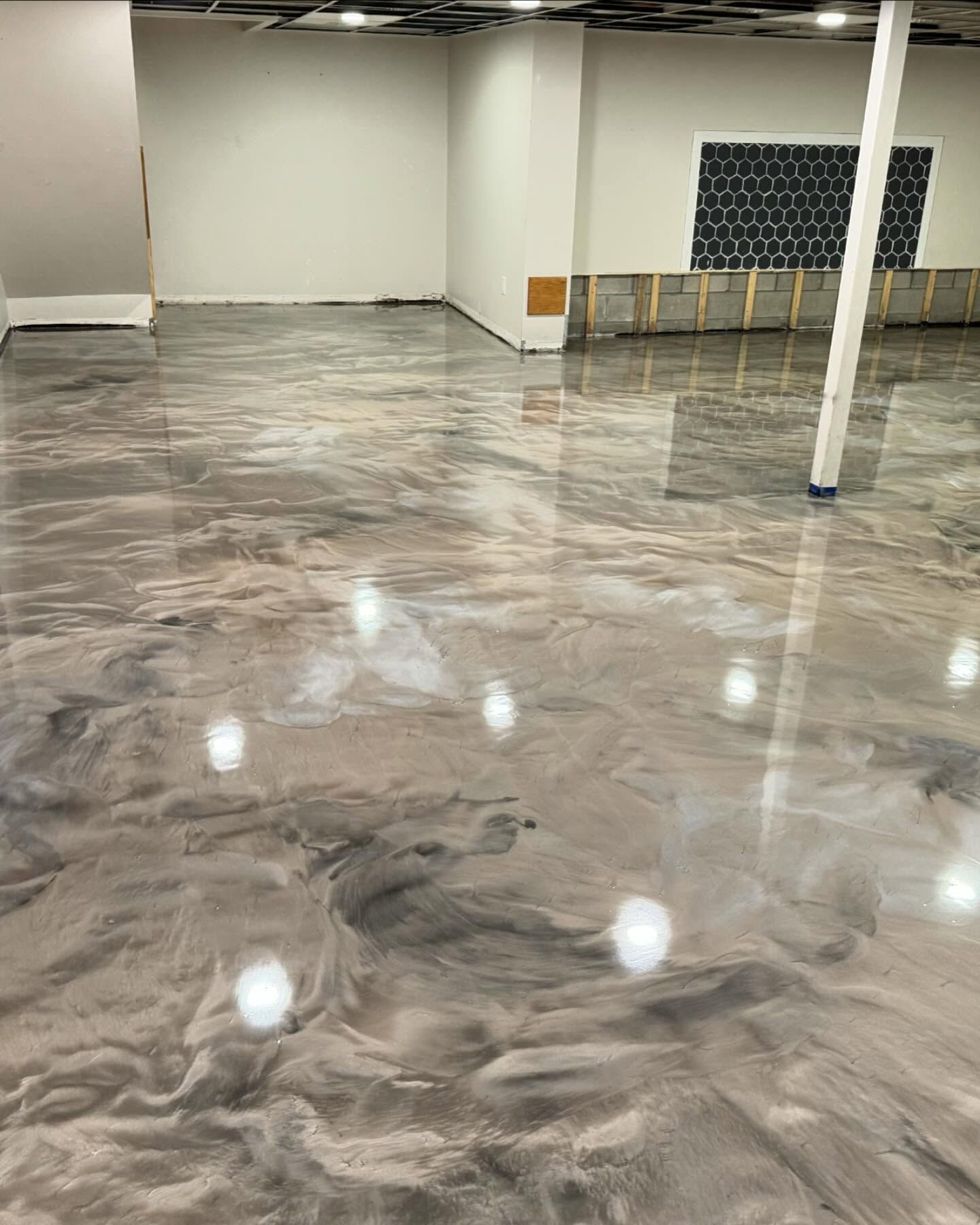 Metallic epoxy basement floor installation in a residential home in Erie, PA