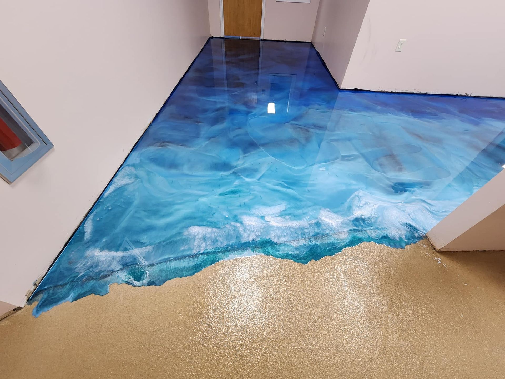Ocean and sand colored metallic epoxy floor with swirling depth from 814 Epoxy and More