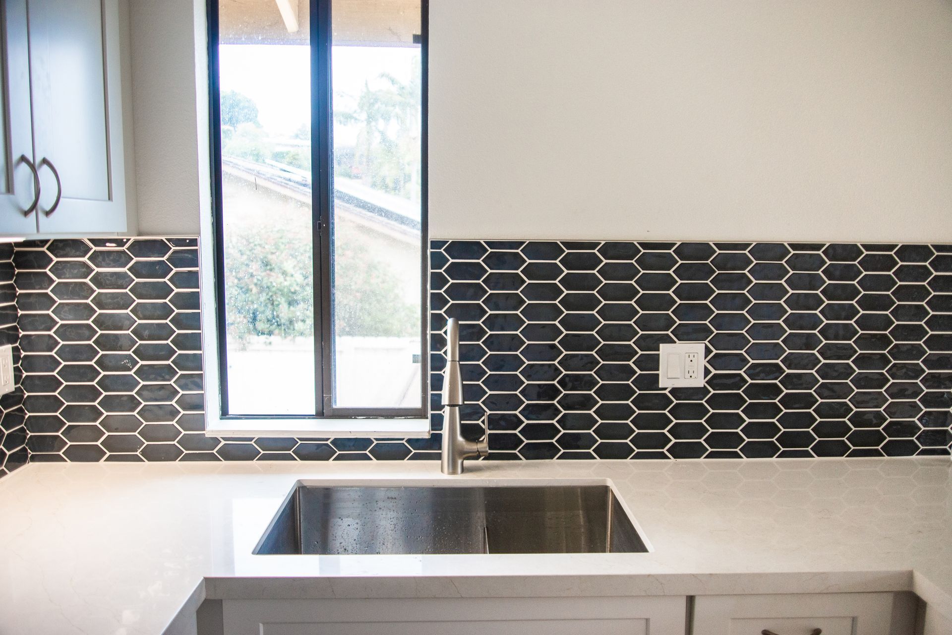 A bathroom with a walk in shower and a sink